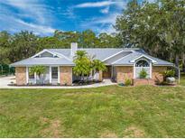 Single-story home with metal roof and landscaping at 4450 Kaiser Ave, St Cloud, FL 34772