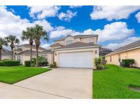 Two-story house with a white garage door and landscaping at 8612 La Isla Dr, Kissimmee, FL 34747