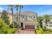 Luxury home with three-car garage and beautiful landscaping at 494 Muirfield Loop, Reunion, FL 34747