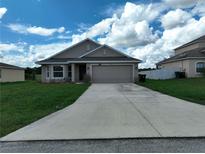 Two-car garage, front yard, and neutral color scheme at 2513 Rock Pl, Kissimmee, FL 34759