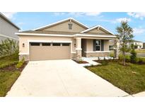 One-story home with stone accents and two-car garage at 176 Flag Lilly Ln, Umatilla, FL 32784