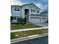 Two story home with light blue exterior at 12351 Northover Loop, Orlando, FL 32824