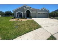 Two-story house with a two-car garage and landscaped yard at 3601 Daydream Pl, Saint Cloud, FL 34772