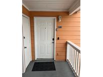 Exterior view of condo building with stairs and private entrance at 8713 Sw Rockingham Ter # D, Kissimmee, FL 34747