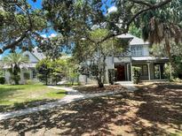 Two-story home nestled amongst lush greenery, showcasing a charming facade at 2086 Camelot Blvd, St Cloud, FL 34772