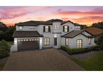 Two-story house with a large driveway and landscaping at 5222 Waterside Vista Ln, St Cloud, FL 34771