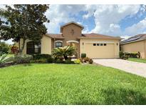 Attractive single-story home with a two-car garage and well-manicured lawn at 709 Carmel Ln, Kissimmee, FL 34759