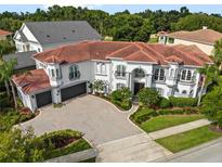 Luxury home with tile roof and large driveway at 7459 Gathering Dr, Reunion, FL 34747