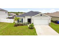 Charming single-story home with a two-car garage and landscaped front yard at 2894 Mosshire Cir, Saint Cloud, FL 34772