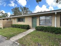 Condo exterior, featuring a green door and landscaping at 725 Northlake Blvd # 52, Altamonte Springs, FL 32701