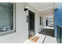 Building exterior with walkway and black door at 15 Escondido Cir # 141, Altamonte Springs, FL 32701