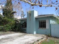 Light blue house exterior with a spacious yard and driveway at 1632 N Fullers Cross Rd, Winter Garden, FL 34787