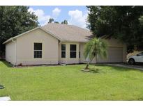 Charming single-story home with a well-maintained lawn at 624 Gull Dr, Poinciana, FL 34759