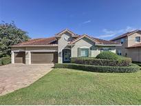 Single-story home with tile roof, two-car garage, and manicured lawn at 3510 Mediterra Dr, Clermont, FL 34711