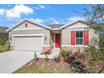 New construction home with red shutters and stone accents at 2043 Stetson Ct, Eagle Lake, FL 33839