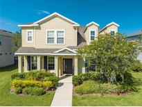 Two story house with landscaping and walkway at 2662 Trafalgar Blvd, Kissimmee, FL 34758