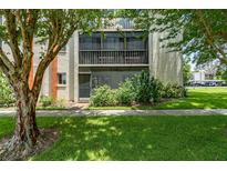 Condo exterior with screened balcony and landscaping at 1130 N Lake Parker Ave # C129, Lakeland, FL 33805