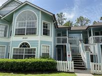 Charming light blue two-story condo with white picket fence at 2022 Royal Bay Blvd # 93, Kissimmee, FL 34746