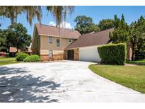 Two-story home with a large driveway and mature landscaping at 1105 Monroe Ave., St Cloud, FL 34769