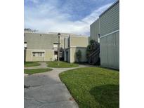 Exterior view of a residential building with landscaping at 116 Scottsdale Sq # 2, Winter Park, FL 32792