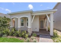 Exterior of charming one-story home with landscaped yard at 15424 Enchanted Melody Way, Winter Garden, FL 34787
