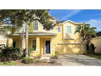 Two-story house with a yellow facade at 14642 Yellow Butterfly Rd, Windermere, FL 34786