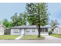 Ranch-style house with gray exterior and a large tree at 225 E Pomelo St, Lake Alfred, FL 33850