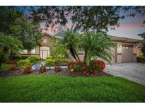 House with a beige exterior and lush landscaping at 154 Rancho Mirage Dr, Kissimmee, FL 34759