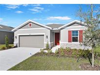 One-story home with gray siding, red shutters, and a two-car garage at 2027 Stetson Ct, Eagle Lake, FL 33839