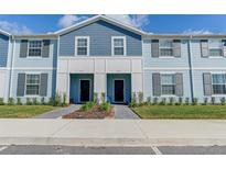 Two-story townhouses with blue siding and gray shutters at 3725 Pacific Ln, Davenport, FL 33897