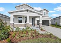 Two-story home with stone accents and a two-car garage at 1413 August Gray Dr, Kissimmee, FL 34744