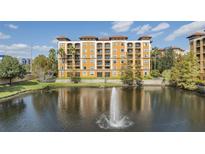 Building with lake view and water fountain at 12544 Floridays Resort Dr # 202B, Orlando, FL 32821