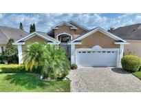 Two-story house with a white garage door at 220 Lewis Dr, Davenport, FL 33837