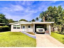 Single-story home with attached carport and a spacious yard at 316 Pennsylvania Ave, Saint Cloud, FL 34769