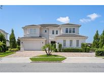 Two-story house with a three car garage and landscaping at 15620 Panther Lake Dr, Winter Garden, FL 34787