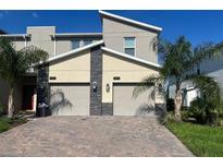 Modern two-story townhome with two-car garage and paver driveway at 1191 Drop Ln # 1191, Davenport, FL 33896