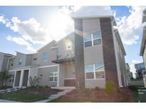 Modern two-story townhome with stone accents at 1038 Splash Shot Pl, Davenport, FL 33896