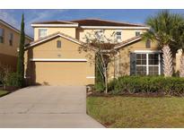 Two-story house with attached garage and landscaping at 5265 Oakbourne Ave, Davenport, FL 33837