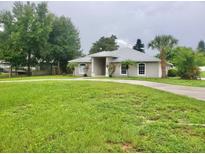 Single story home with large front yard and circular driveway at 1025 W Lake Hamilton Dr, Winter Haven, FL 33881