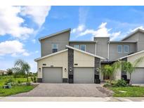 Modern two-story townhome with two-car garage and attractive exterior finishes at 9355 Sommerset Hills Dr # 9355, Davenport, FL 33896