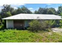 Ranch-style home with metal roof, needing repairs at 2795 Absher Rd, Saint Cloud, FL 34771