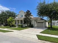Two-story house with attached garage and landscaped yard at 4980 W Castle W St, Kissimmee, FL 34758