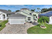 House exterior with a screened garage and landscaped yard at 117 Ridge View Dr, Davenport, FL 33837