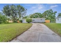 Newly renovated home with gray exterior and driveway at 1318 Terre Cia Ave, Orlando, FL 32807