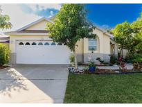 Attractive single-story home with a well-maintained lawn and a two-car garage at 162 Seneca Point Trl, Kissimmee, FL 34746