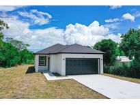 New construction home with a black garage door at 48 Atlantic Ave, Babson Park, FL 33827