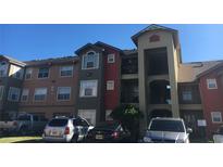 Exterior view of a two-story apartment building with ample parking at 2203 Key West Ct # 436, Kissimmee, FL 34741