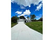 New construction home with gray siding and a two-car garage at 1339 Tallahassee Ct, Kissimmee, FL 34759