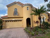 Two-story house with attractive landscaping and a large garage at 11774 Via Lucerna Cir, Windermere, FL 34786