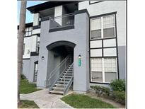 Exterior view of a two-story building with stairs and landscaping at 3701 Castle Pines Ln # 3914, Orlando, FL 32839